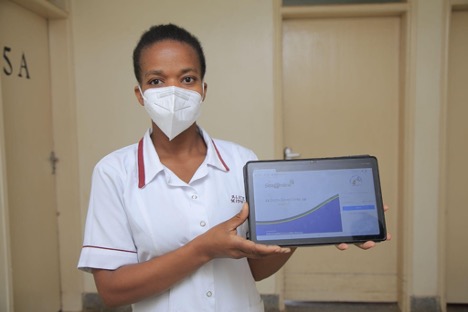 A nurse shows off Stre@mline EMR at Divine Hospital in Mbarara district